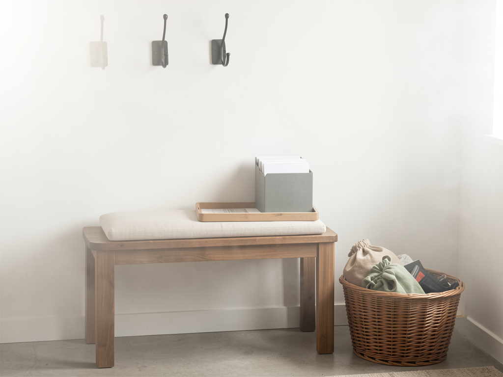 Small entry drop zone with hooks, tray for keys, mail slot, bench, and woven basket - finished detail